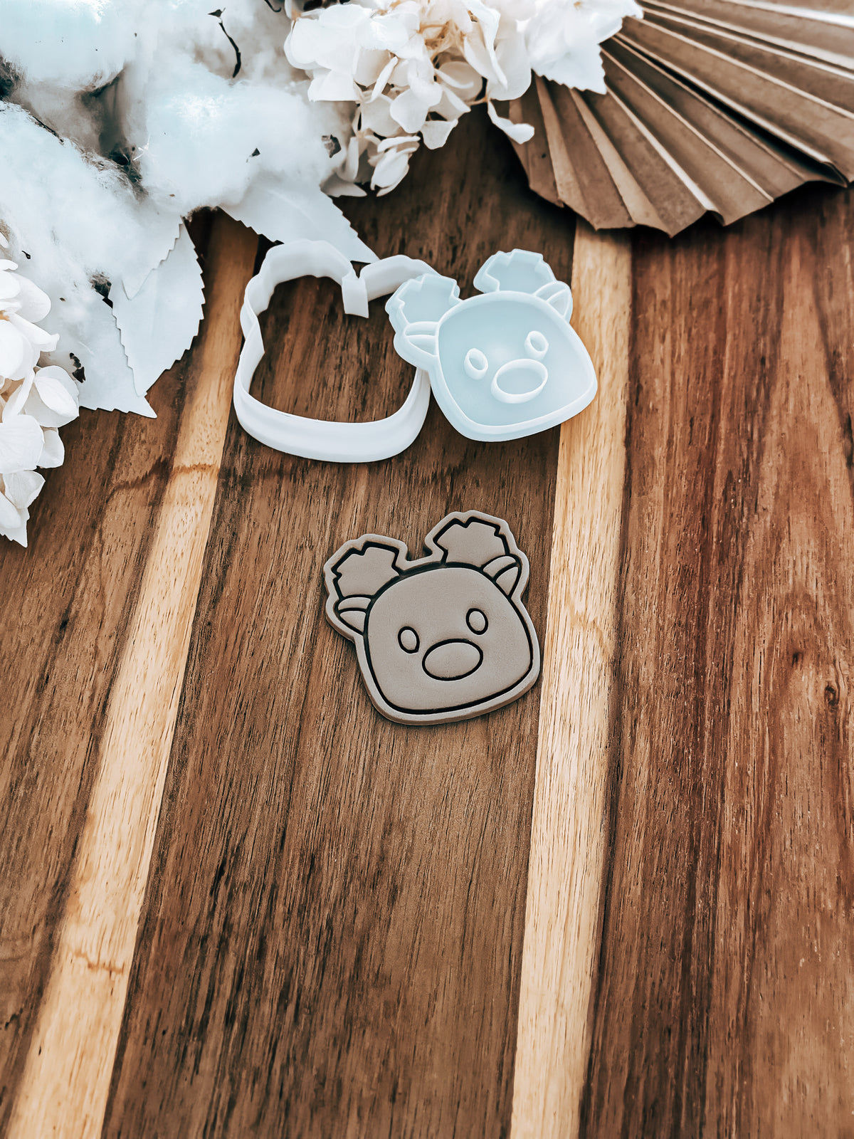 Mini Simple Reindeer Christmas cookie stamp and cutter by O'Khach, shown stamped in fondant