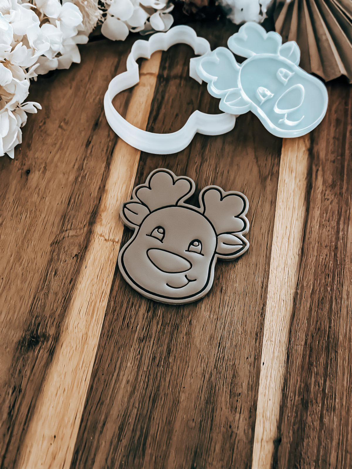 Dasher (reindeer) Christmas cookie stamp and cutter by O'Khach, shown stamped in fondant