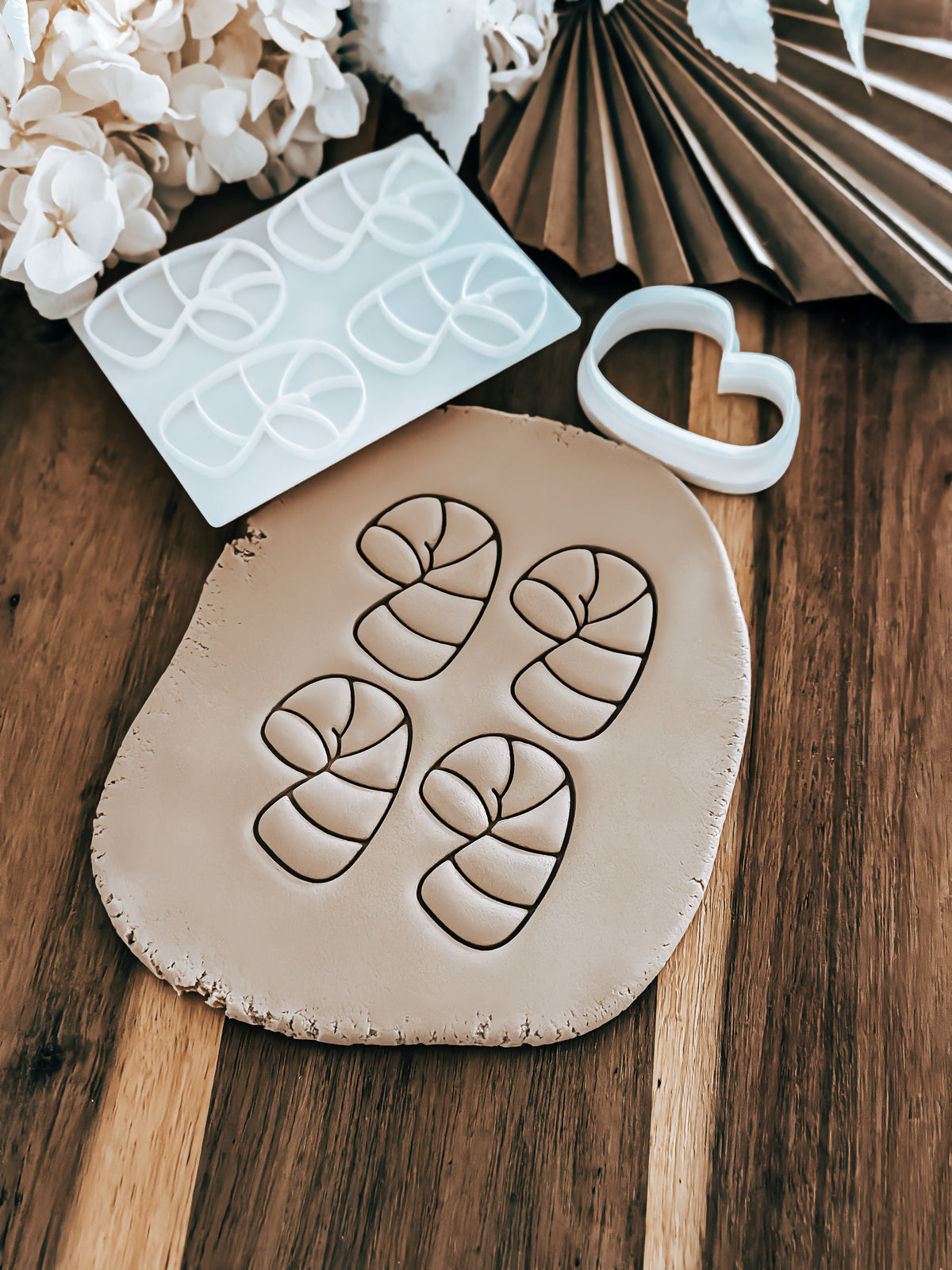 Mini Multi - Candy Cane Christmas cookie stamp and cutter by O'Khach, shown stamped in fondant