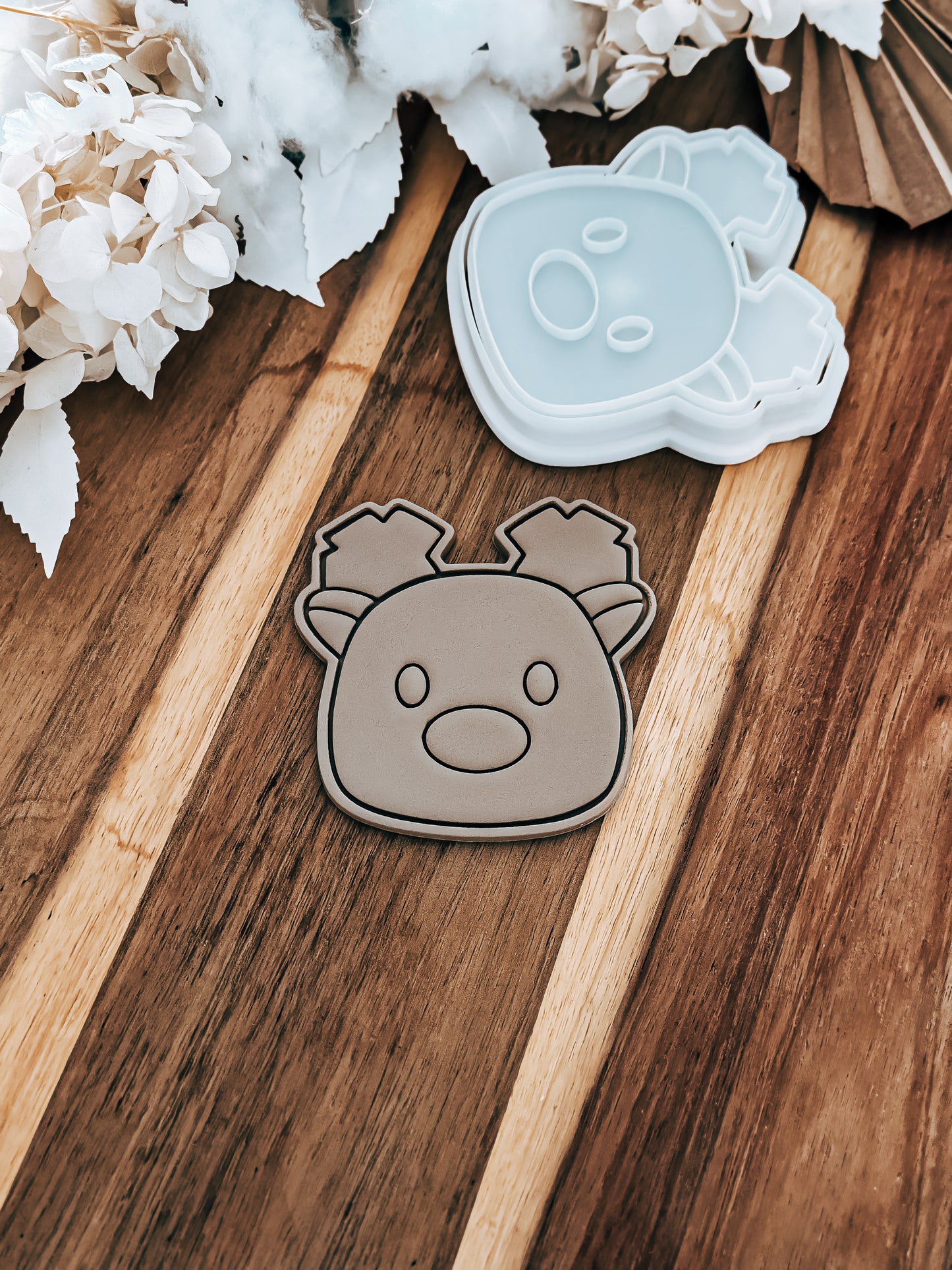 Simple Reindeer Christmas cookie stamp and cutter by O'Khach, shown stamped in fondant