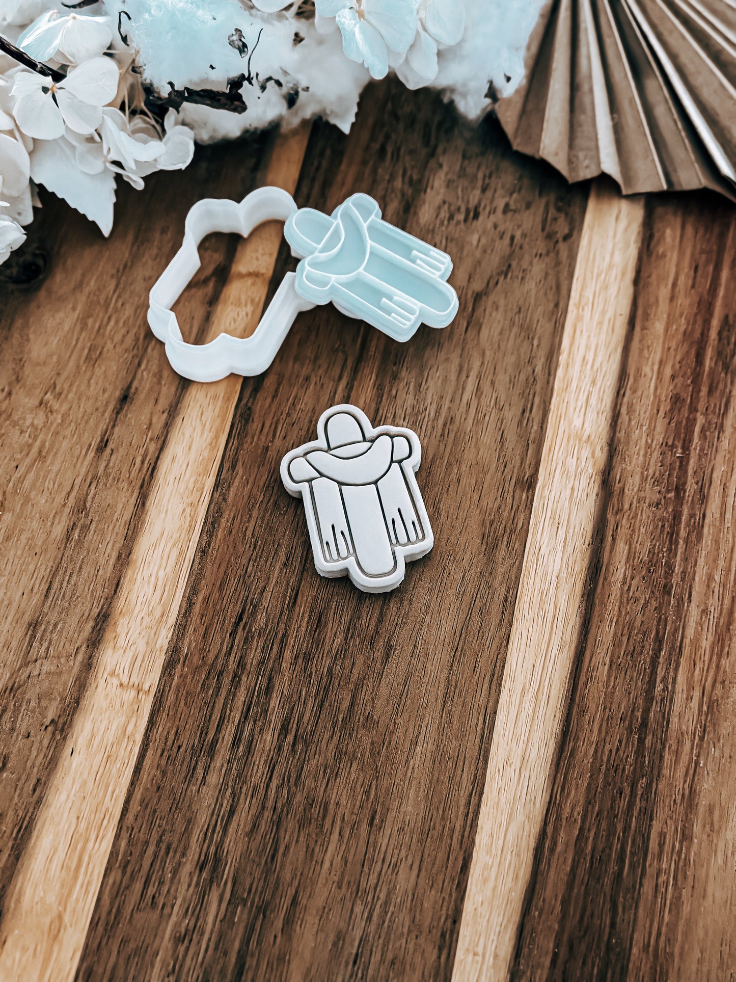 Mini Draped Grace Cross cookie stamp and cutter by O'Khach, shown stamped in fondant