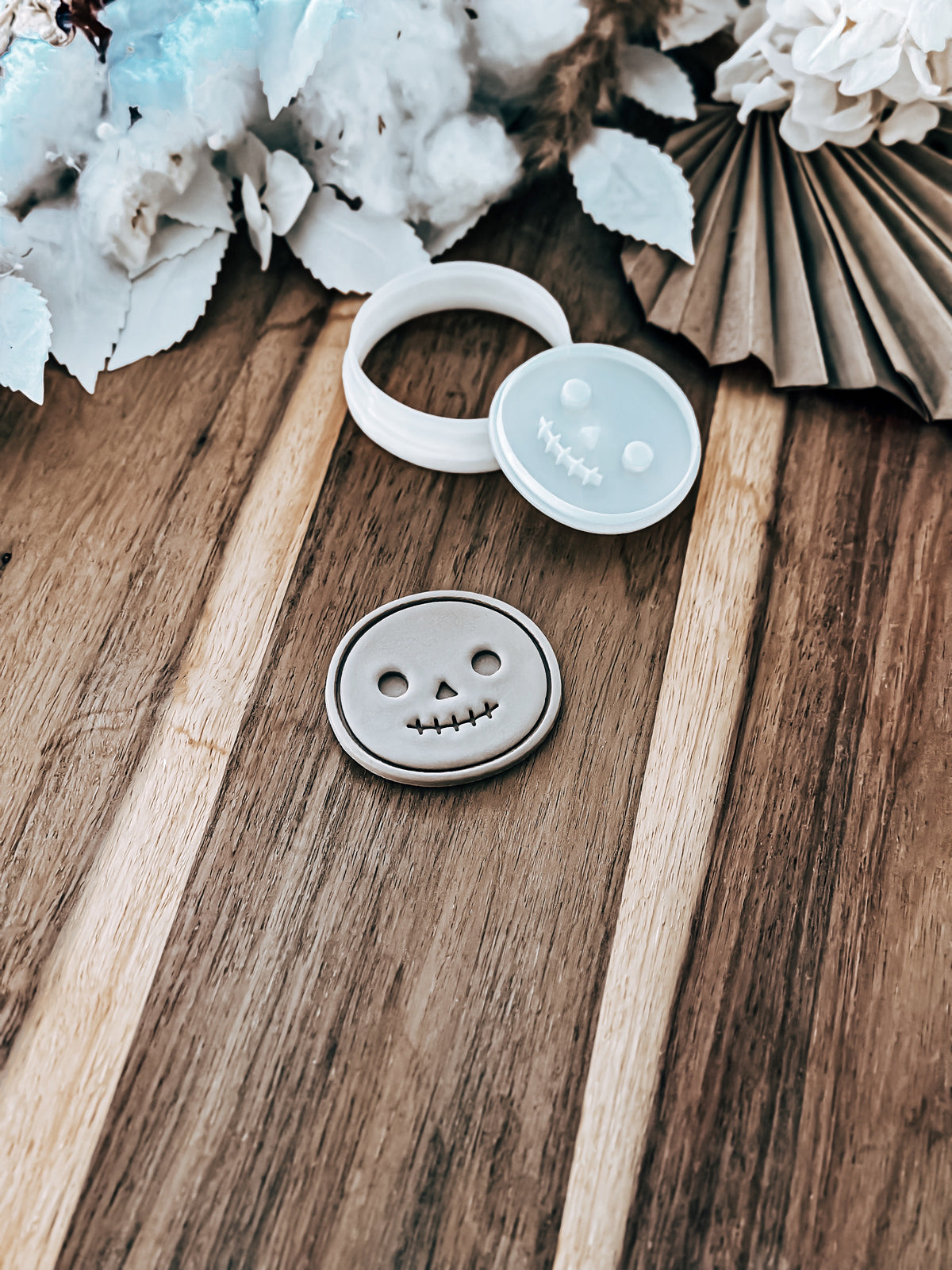 Mini Smiley cookie stamp and cutter by O'Khach, shown stamped in fondant