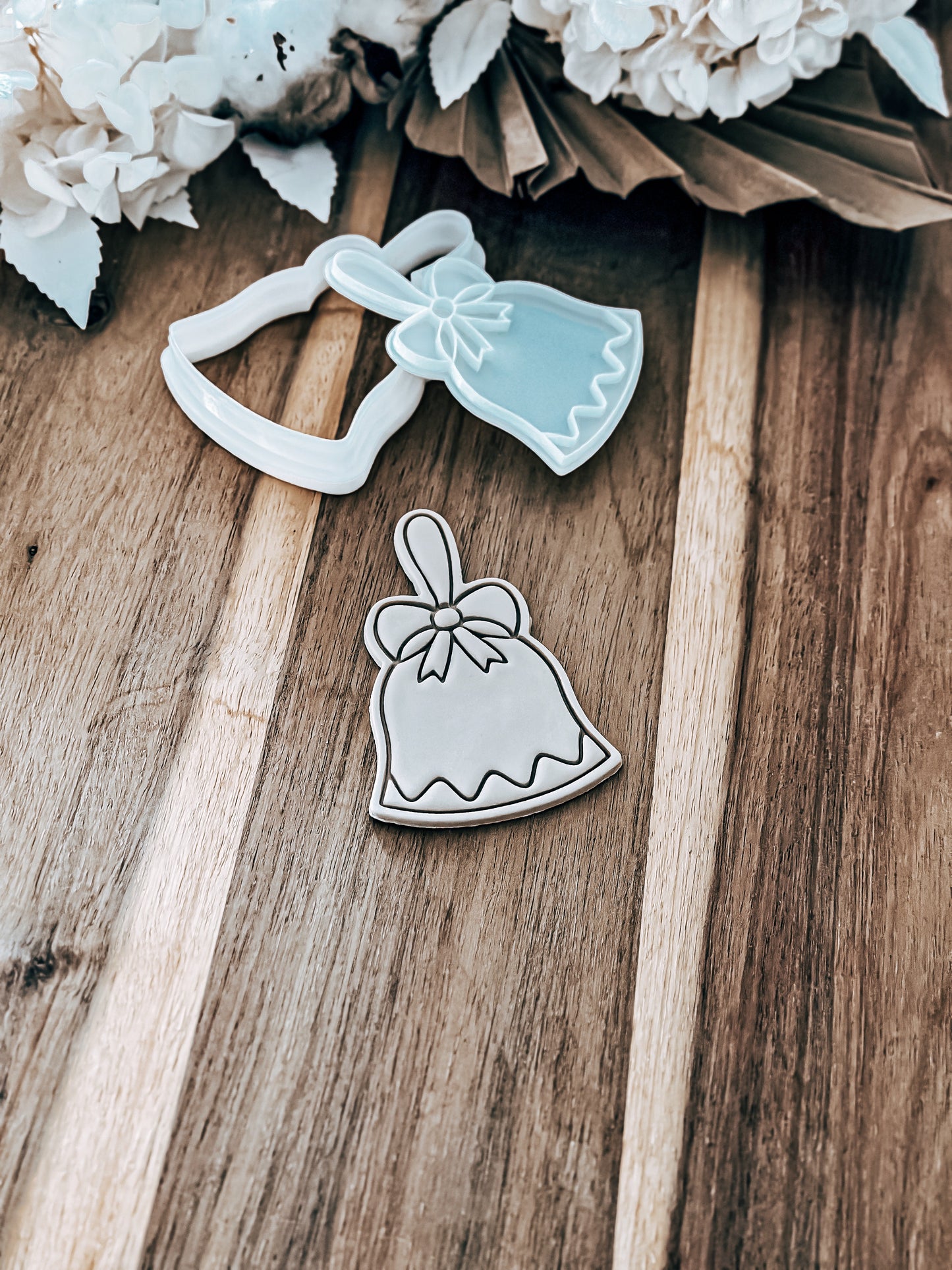 Christmas Bell cookie stamp and cutter by O'Khach, shown stamped in fondant