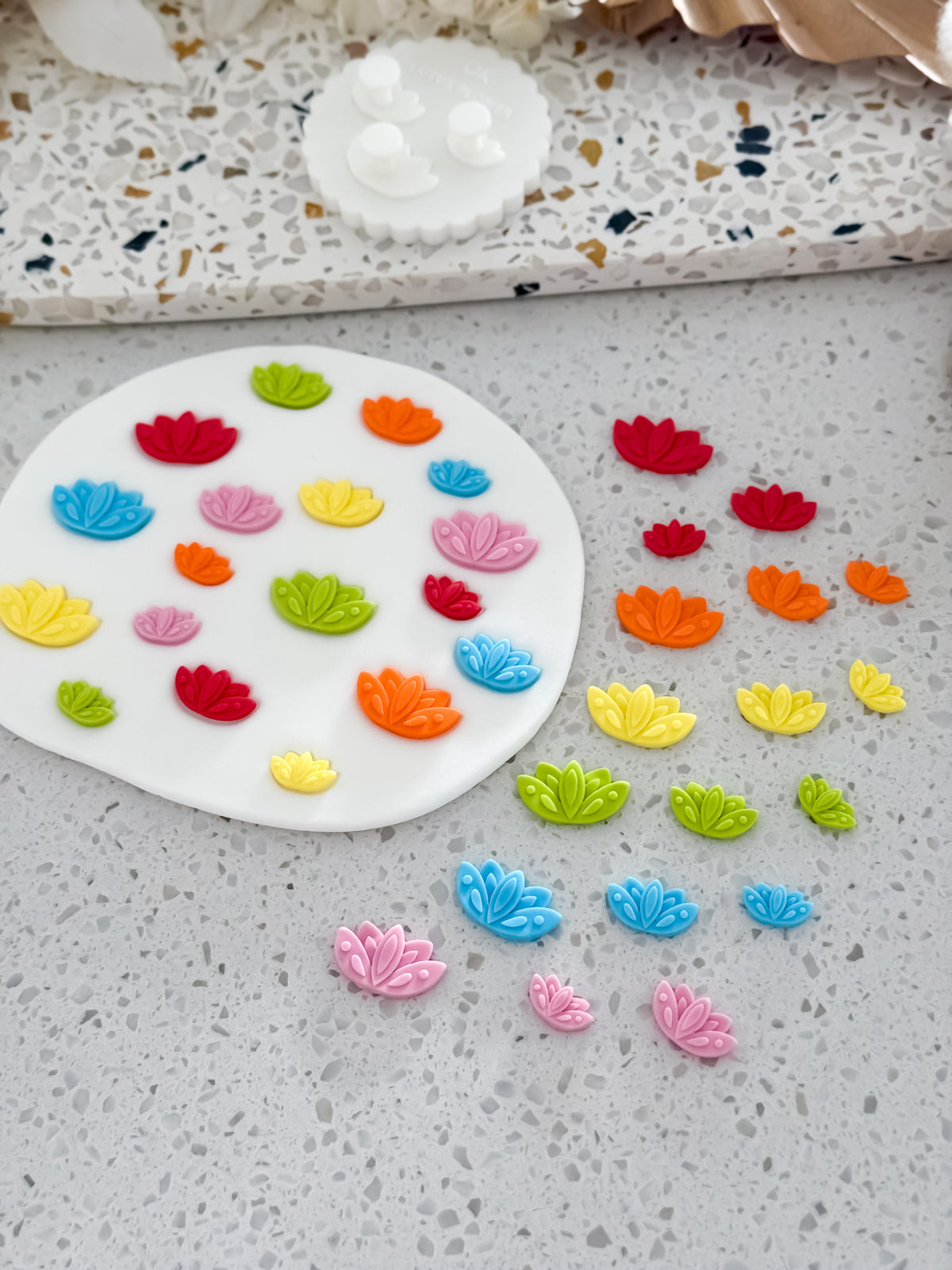 Rainbow lotus flower fondant pieces in three sizes made with the Lotus Flower Two Tone Press mould by O'Khach Baking Supplies