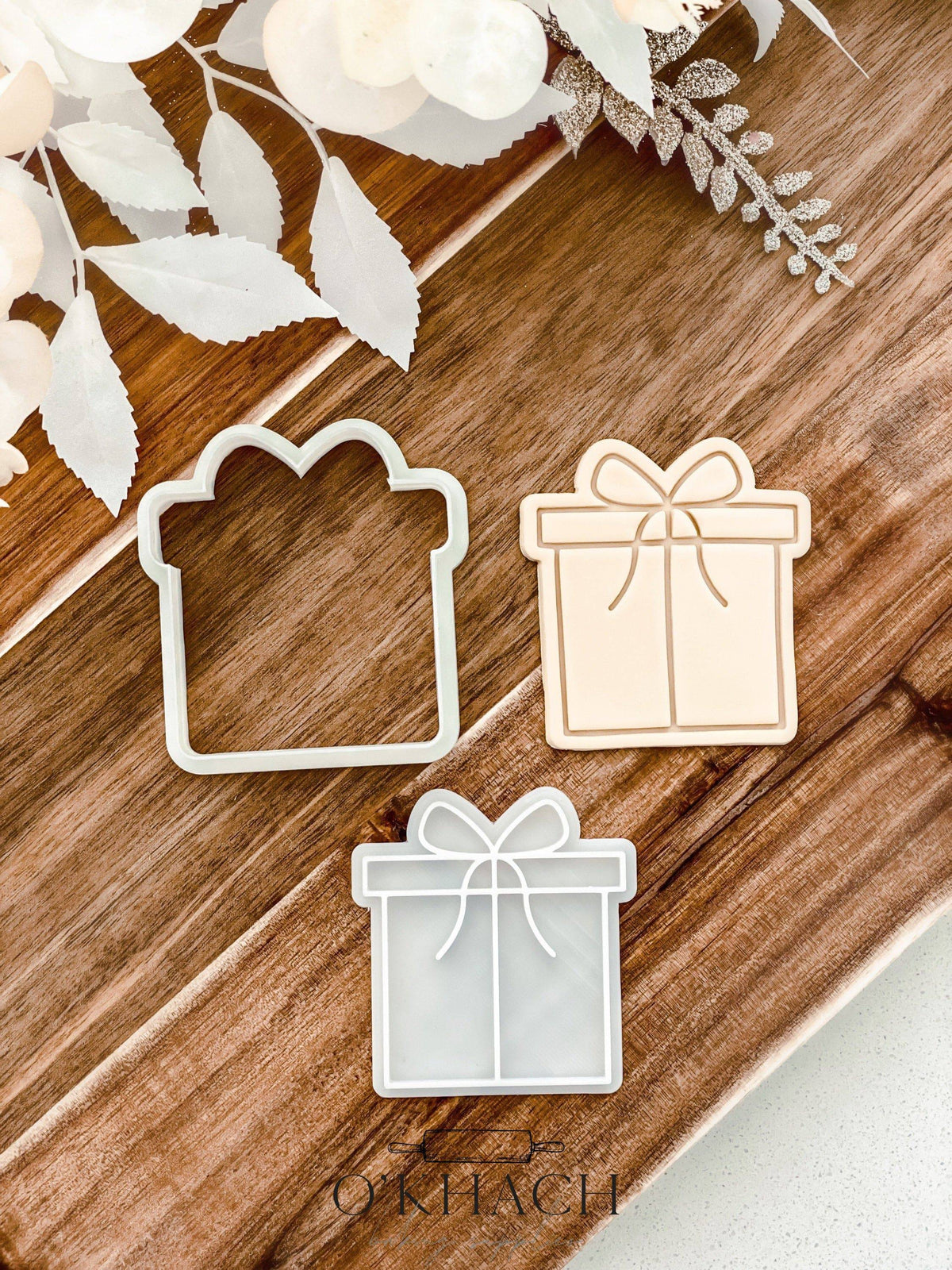 Bow Present Christmas cookie stamp and cutter by O'Khach, shown stamped in fondant