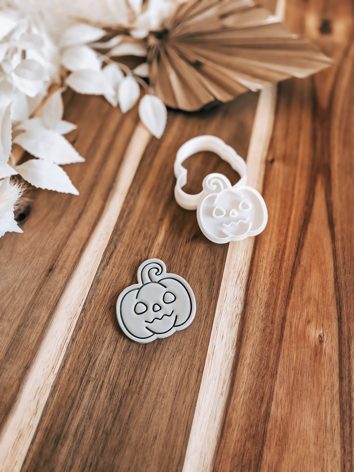 Mini Face Pumpkin Halloween cookie stamp and cutter by O'Khach, shown stamped in fondant