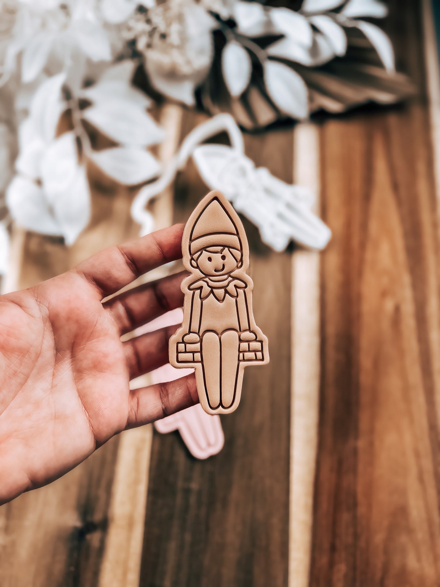 Cheeky Elf Christmas cookie stamp and cutter by O'Khach, shown stamped in fondant