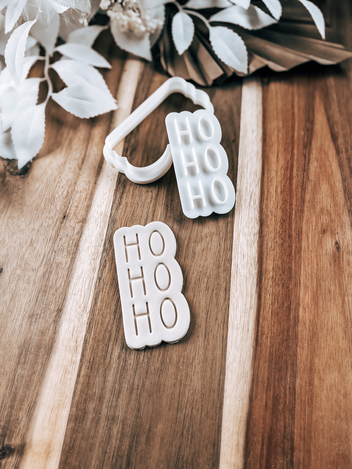 Ho Ho Ho Christmas cookie stamp and cutter by O'Khach, shown stamped in fondant