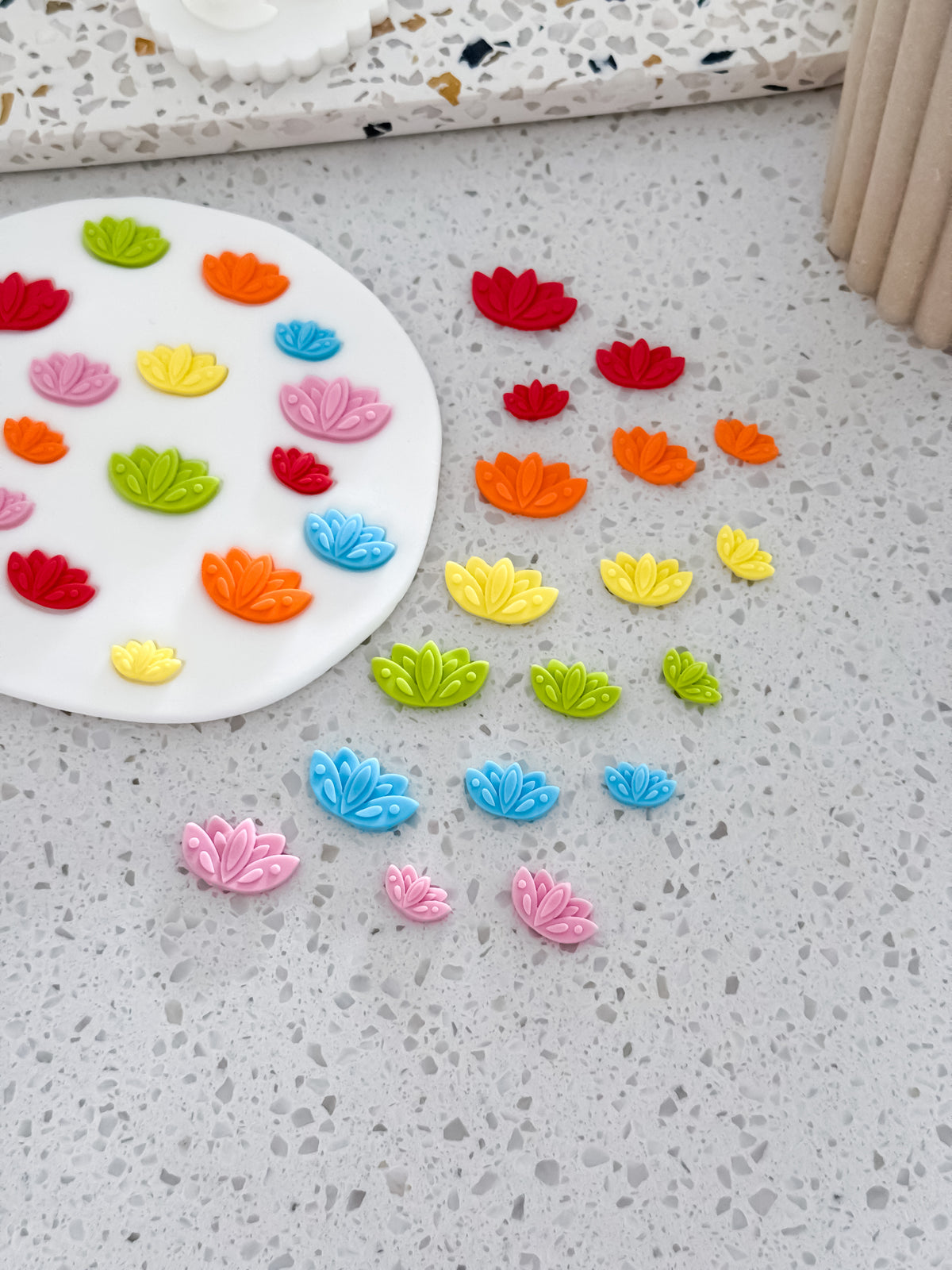 Lotus flower mini fondant decorations in red, orange, yellow, green, blue and pink for Diwali cookies