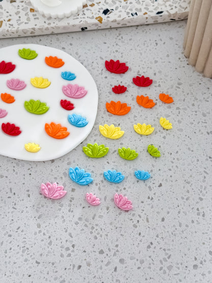 Lotus flower mini fondant decorations in red, orange, yellow, green, blue and pink for Diwali cookies
