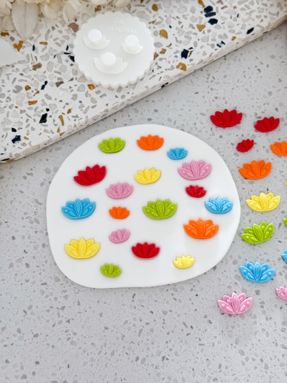 Lotus Flower Two Tone Press mould with storage base and lotus fondant pieces on white fondant